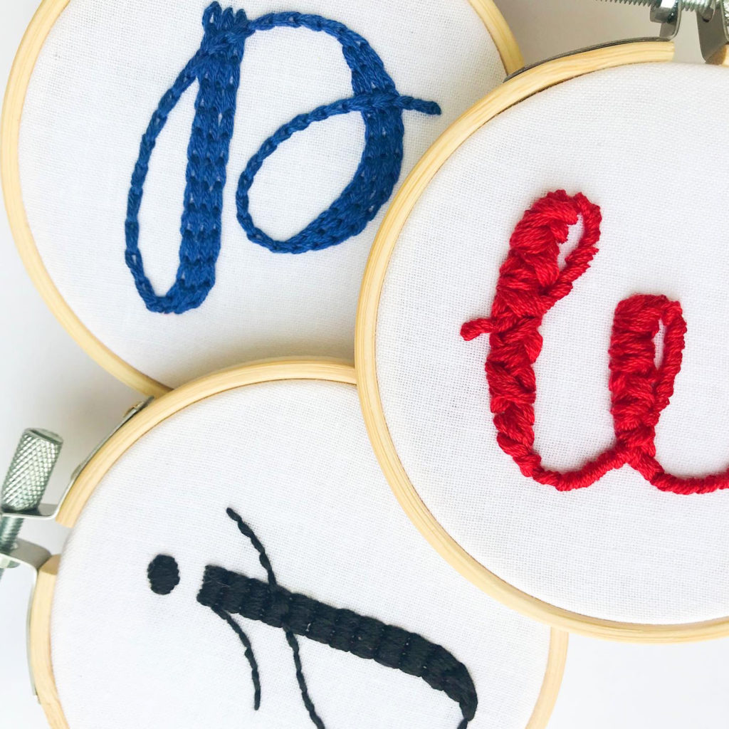 DIY Christmas Ornaments - Initial ornament hoops for the letters, "P, W & J." Each hoop is a different color and a different stitching style
