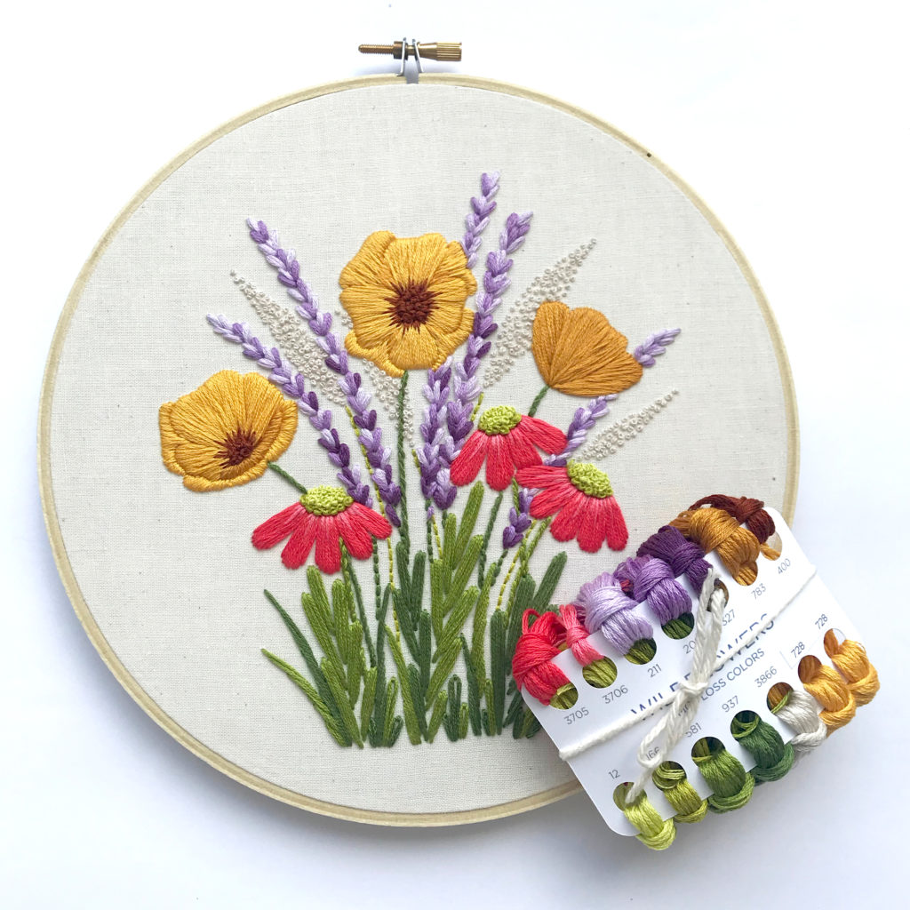 Wildflower hoop featuring yellow, purple, and pink flowers. Also shown is the floss. 