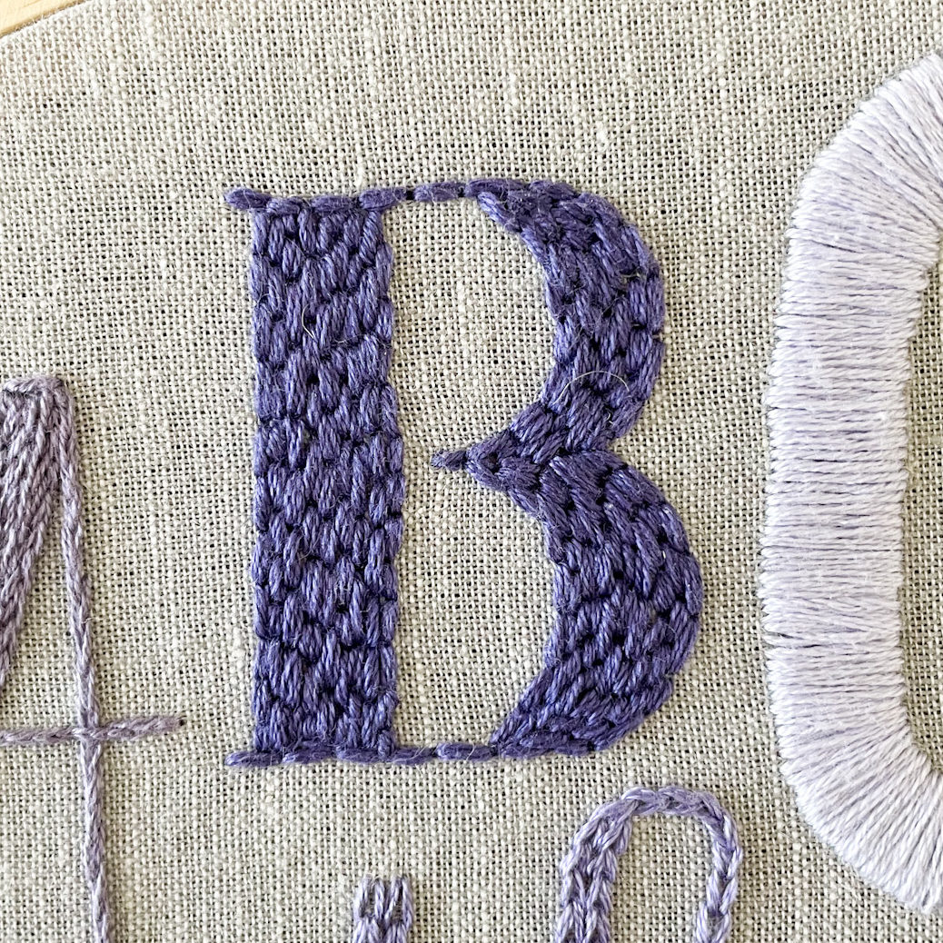 The letter B filled with brick stitch.