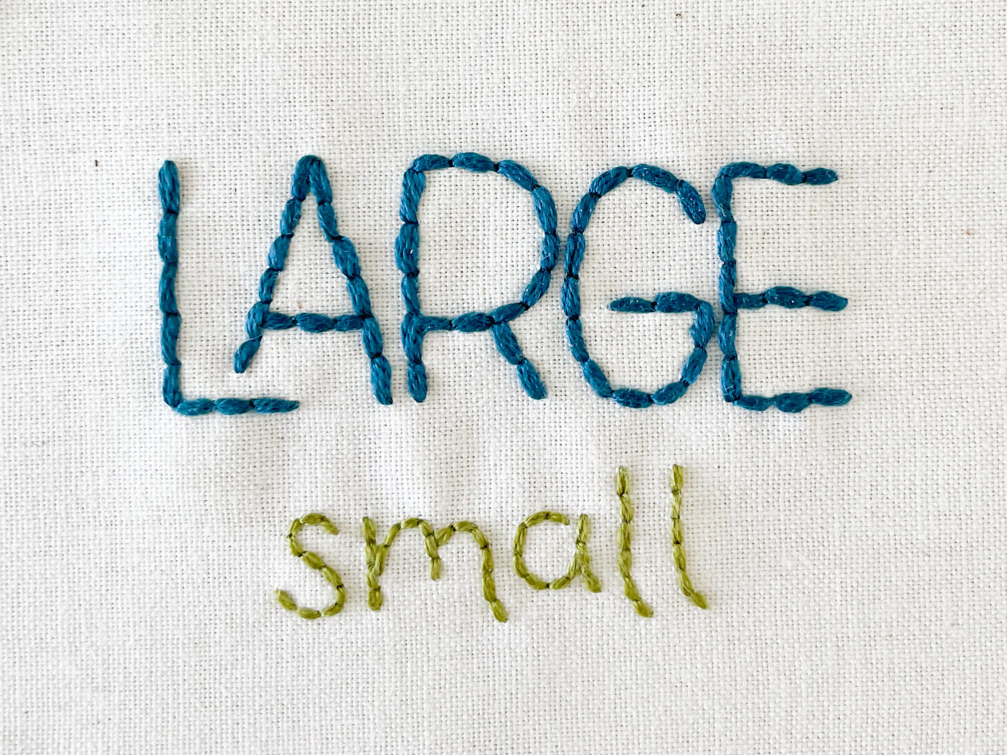 The words "Large" and "small" stitching on fabric.